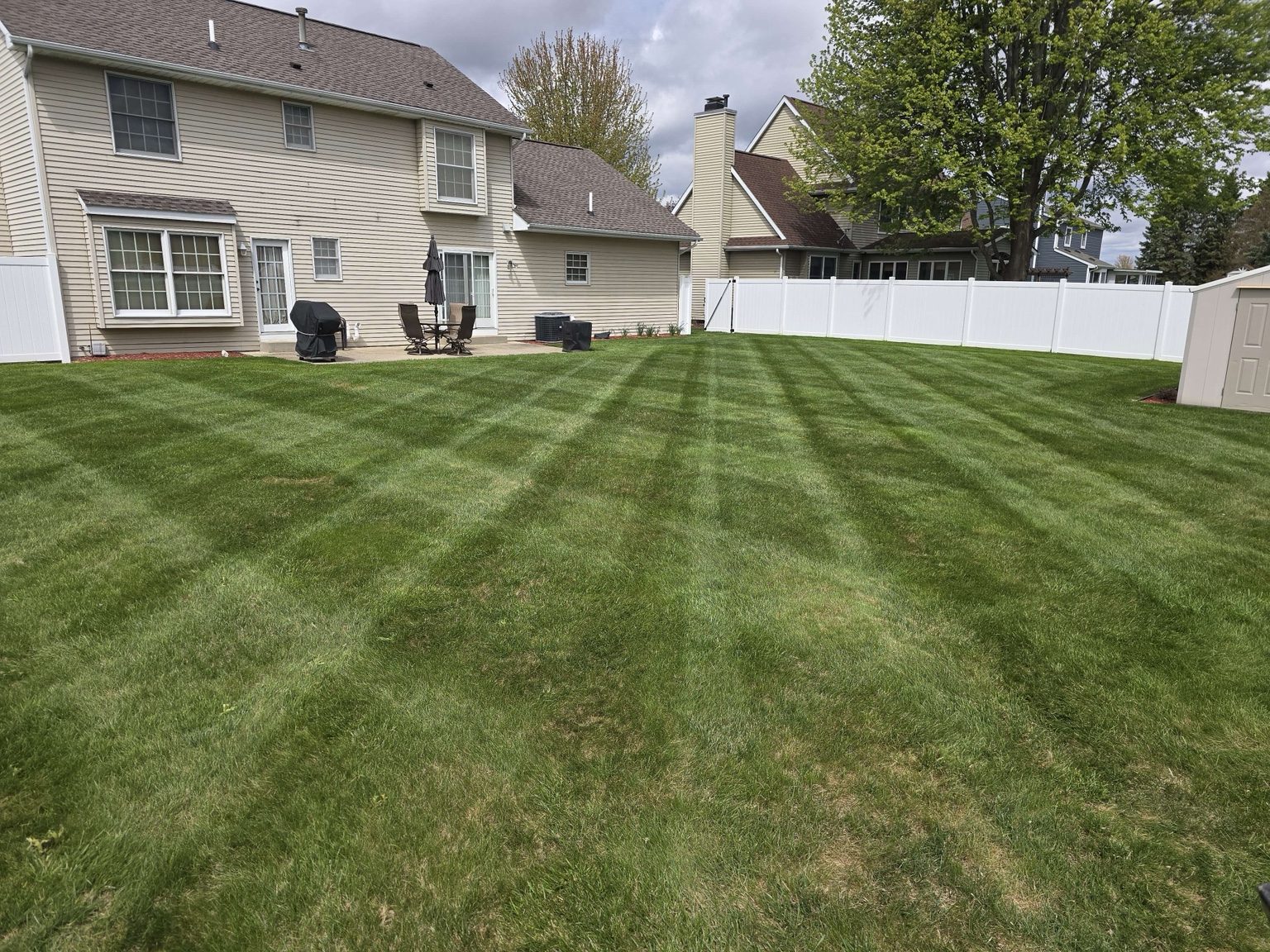 Freshly striped residential lawn maintained by Birdsall Lawn & Property Service LLC